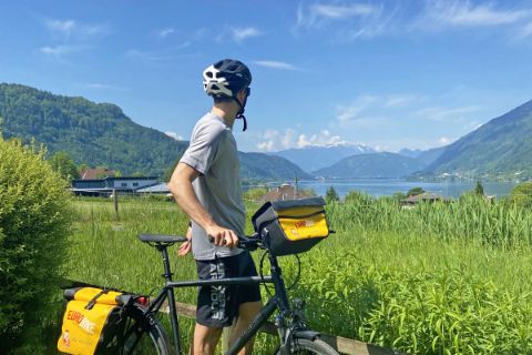 Cyclist looks at the lake Ossiach in Carinthia