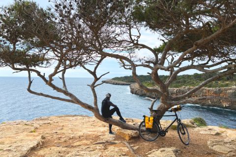 Cyclist takes a break by the sea