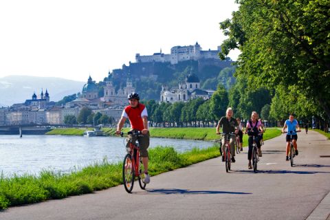 Cyclists at the bank of the river Salzach in Salzburg