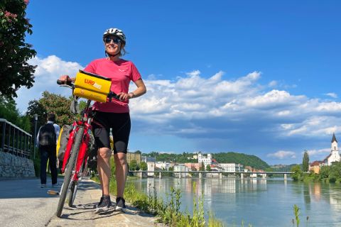 Cyclist on the banks of the Inn in Passau