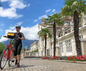 Cyclist on main square in Merano