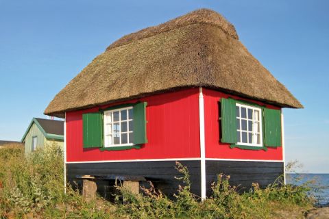 House with thatched roof on the coast 
