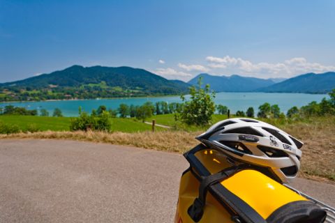 Cycle helmet in front of the scenery of Lake Tegernsee