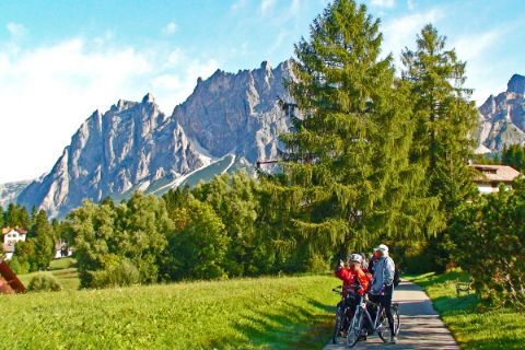 Cyclists in front of the Dolomites