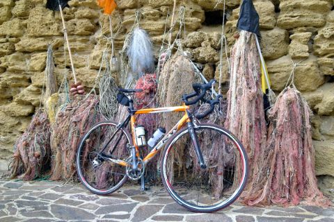 Bike leaning on a wall with fishing nets