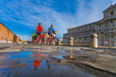 Cyclists on the Piazza dei Miracoli in Pisa