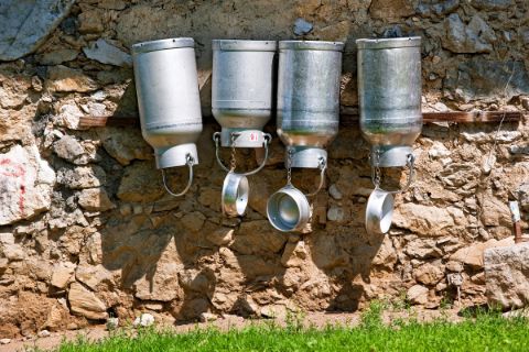 Milk pots on stone wall