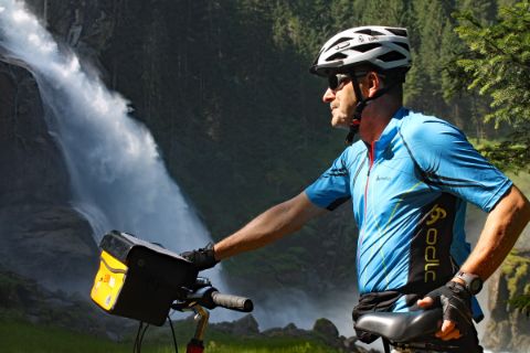 Cyclist in front of waterfall