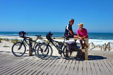 Two women with bikes at the beach