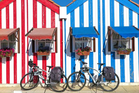 Bikes in front of colourful beach huts on the Atlantic Ocean
