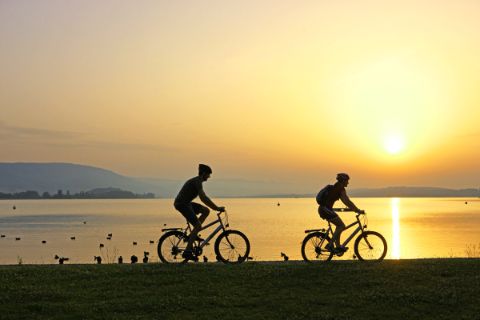 Cyclists at the lake at sunset