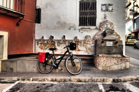Bike in front of antique wall in Agres