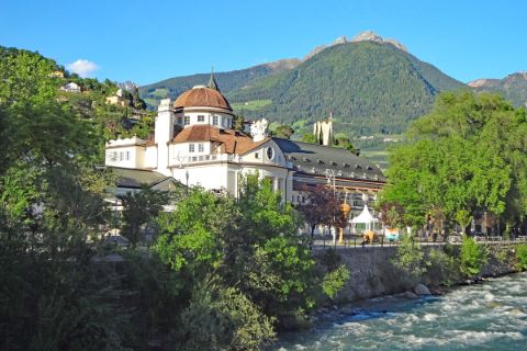 Hiking along river Passer with view to the Kurhaus of Merano