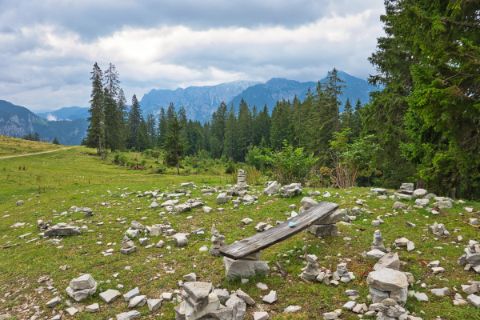 Rest area on the Postalm with a makeshift wooden bench and many stones