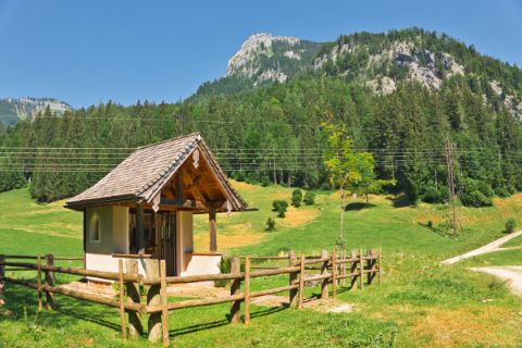 Alpine meadows with Hubertus chapel and mountain panorama