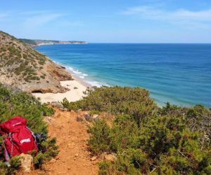 Hiking backpack in front of hiking panorama in algarve bay