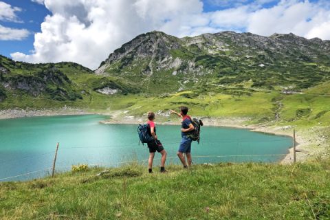 Hikers at the Formarinsee lake in Lech am Arlberg 