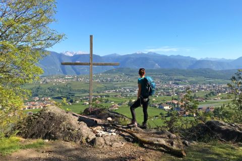 Hiker marvels at the panoramic view onto the Adige Valley