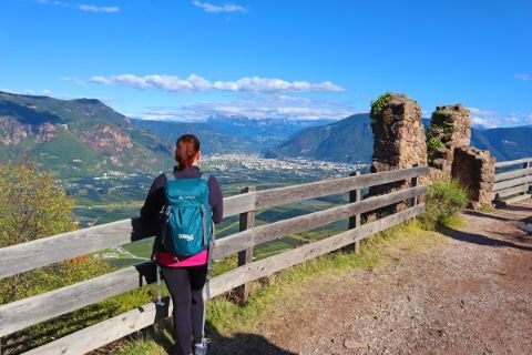 Hiker looks out over Bolzano and the Dolomites