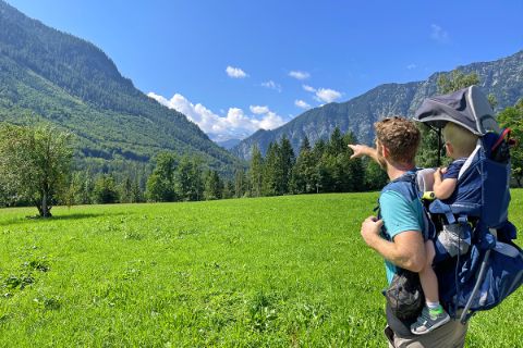 Father and son with carrying backpack hiking in Koppental valley
