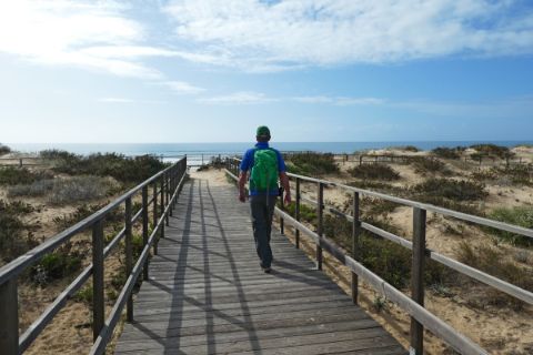 Hiker on the beach path in Algarve