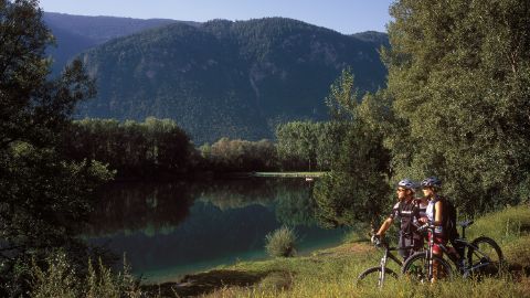 Two mountain bikers take a break on the lakeshore.