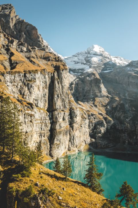 Lake Oeschinen is surrounded by steep cliffs.