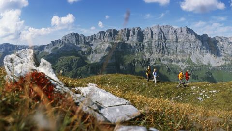 Hikers walk through the Urnerboden in the canton of Uri near the Klausen Pass.
