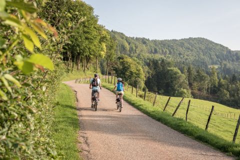 Deux cyclistes roulent sur la Route Verte près de Sceut dans le canton du Jura.